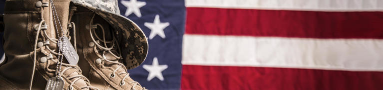 Military boots in front of the US flag.